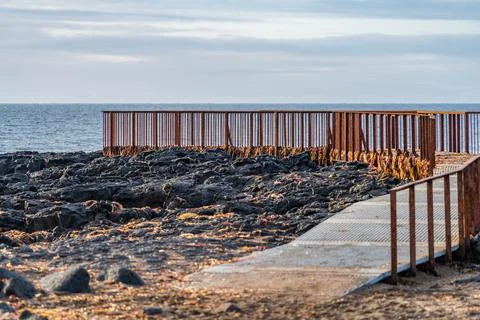 Rusty viewpoint to the ocean over the lava fields Stock Photos