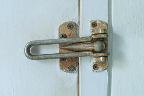 Rusty Vintage Door Security Guard And Latch On White Wooden Door Close Up Stock Photos