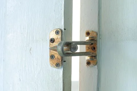 Rusty Vintage Door Security Guard And Latch On White Wooden Door Close Up Stock Photos