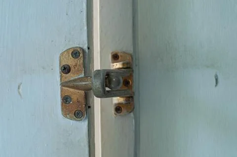 Rusty Vintage Door Security Guard And Latch On White Wooden Door Close Up Stock Photos