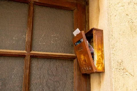 Rusty Wall Mailbox Beside Textured Window Stock Photos