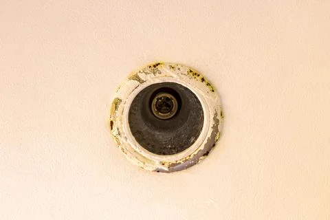 Rusty wall mounted light bulb holder showing vintage electrical fixture Tha.. Stock Photos