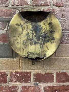 Rusty Wall-Mounted Metal Container on Old Brick Facade Photos