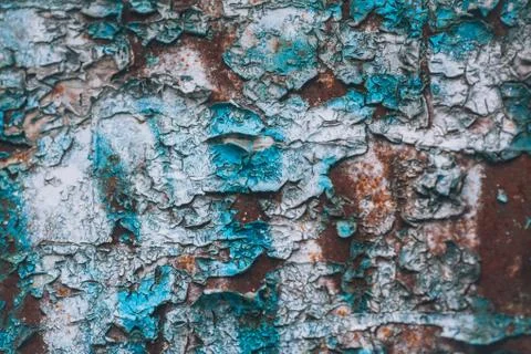 Rusty wall with paint, grunge texture. Layers of old peeling paint on an iron su Stock Photos