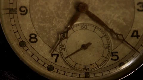 Rusty watch hands tick slowly across an old face Stock Footage 329598369