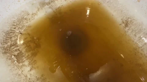 Rusty water flows into the white tub from the tap. Stock Footage 152018513
