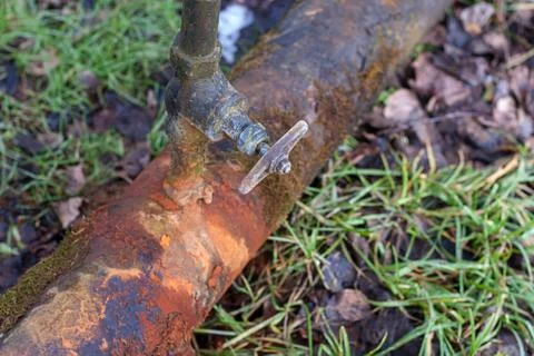 Rusty water pipe with leaking tap Fotos Stock