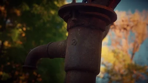 Rusty water pump standing in a garden in autumn Stock Footage 292787884