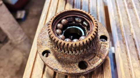 Rusty wheel bearing with visible internal components, symbolizing age, damage Stock Footage 332469618