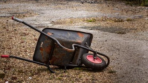 Rusty wheelbarrow neglected Stock Photos
