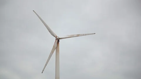Rusty wind generator closeup, grey sky bg Video stock 97101141