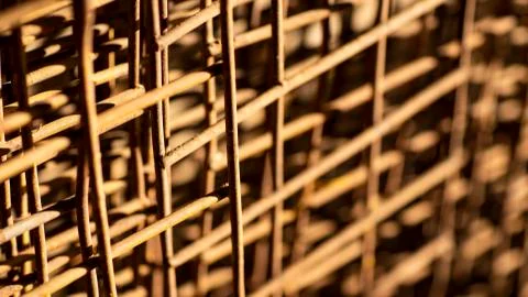 Rusty wire grid, blurred background. Stock Photos