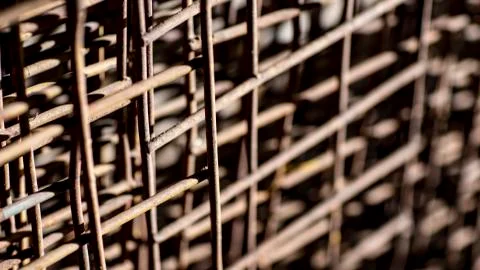 Rusty wire grid, blurred background. Stock Photos