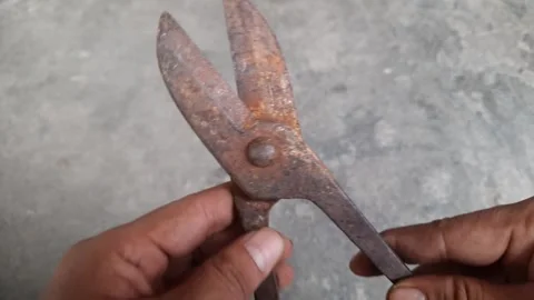 Rusty wire scissors in someone's hand, metal cutting tool Stock Footage 250623650