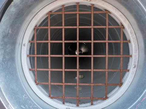 Rusty worn down pipe and grate with faint other side Stock Photos