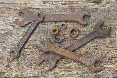 Rusty wrenches and nuts on old unpainted boards Stock Photos