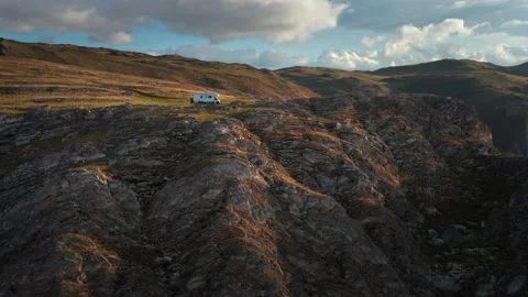 RV camper van on mountains landscape near high cliff, aerial shot Stock Footage 201406032