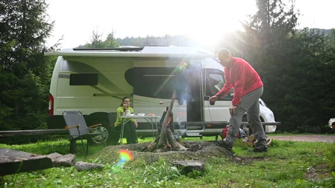 RV Camper Van Road Trip and Camping with Campfire Stock Footage 141013335