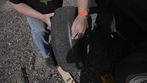 RV, checking a damaged tire, on trailer, driving Stock Footage 151657583
