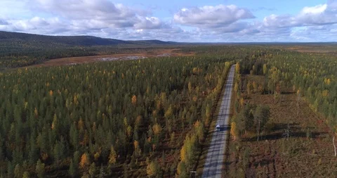 RV on a forest road, Aerial, reverse, drone shot, tilting towards a camper va Stock Footage 118701701
