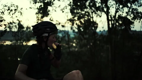 Rwanda - 3 September 2018: a cyclist in a stop eats a banana and drinks Stock Footage 138632840