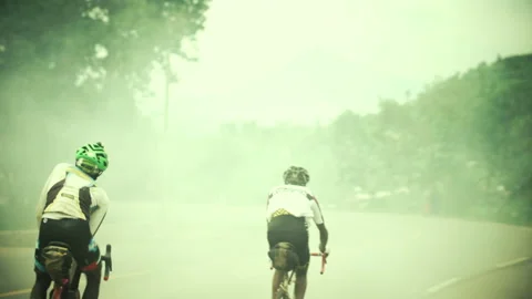 Rwanda - 3 September 2018: two cyclists pedal together Stock Footage 138630999