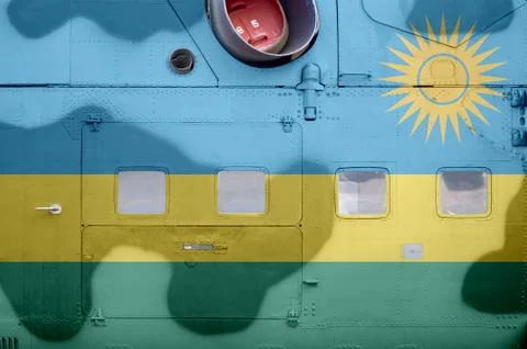 Rwanda flag depicted on side part of military armored helicopter closeup. Arm Stock-Fotos
