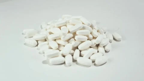 RX White Pills Piled Rotating LtoR White Stock Footage 311894813