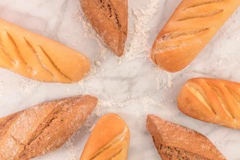 Rye and wheat bread with flour on white marble Foto stock