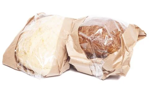 Rye and white bread in a paper bag isolated on white background. Stock Photos