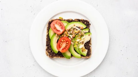 Rye bread and avocado healthy toast Stock Footage 120697769