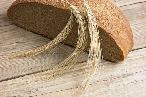 Rye bread, and corn on a wooden table Stock Photos