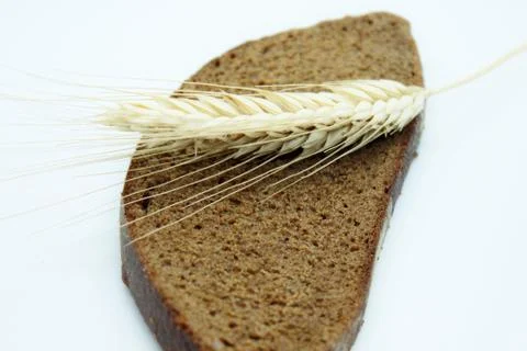 Rye bread and rye ear located on a white background Stock Photos