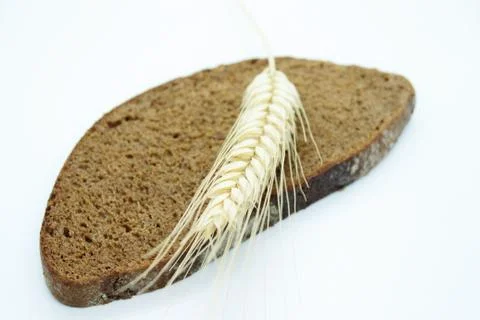 Rye bread and rye ear located on a white background Stock Photos