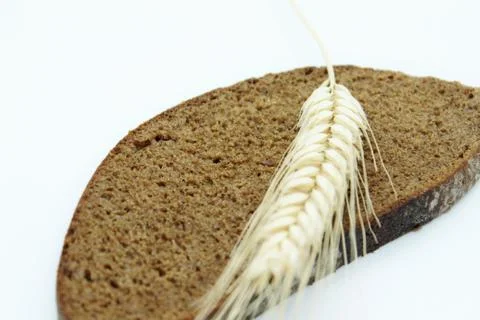 Rye bread and rye ear located on a white background Stock Photos