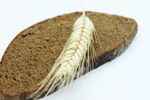 Rye bread and rye ear located on a white background Stock Photos