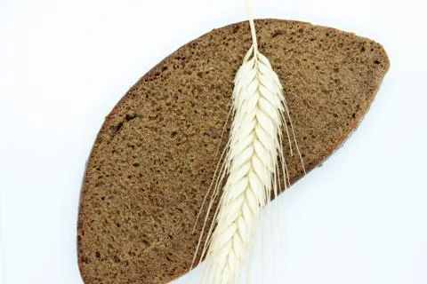 Rye bread and rye ear located on a white background Stock Photos