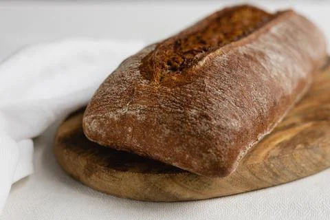 Rye bread on a board on a white tablecloth background Stock Photos