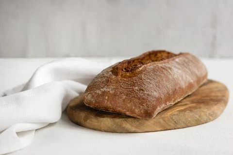 Rye bread on a board on a white tablecloth background Stock Photos
