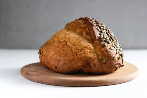 Rye bread on a board on a white tablecloth background Stock Photos