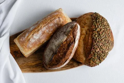 Rye bread on a board on a white tablecloth background Stock Photos