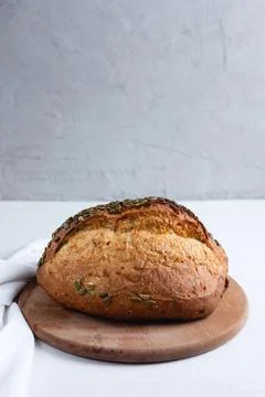 Rye bread on a board on a white tablecloth background Stock Photos
