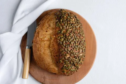 Rye bread on a board on a white tablecloth background Stock Photos