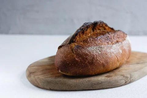 Rye bread on a board on a white tablecloth background Stock Photos