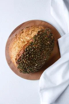 Rye bread on a board on a white tablecloth background Stock Photos