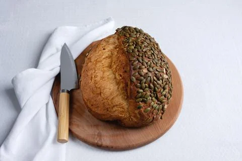 Rye bread on a board on a white tablecloth background Stock Photos