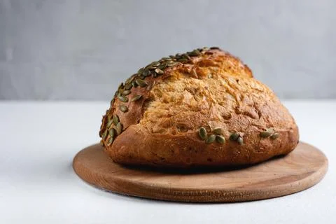 Rye bread on a board on a white tablecloth background Stock Photos