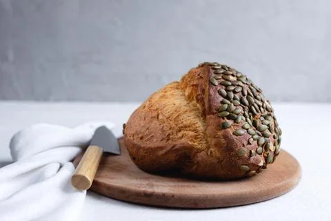 Rye bread on a board on a white tablecloth background Stock Photos