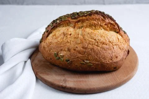 Rye bread on a board on a white tablecloth background Stock Photos
