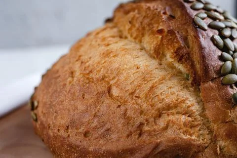 Rye bread on a board on a white tablecloth background Stock Photos